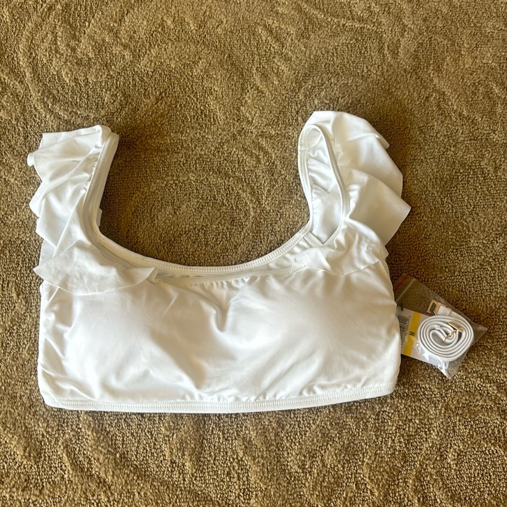 - Brand new Vince Camuto swimwear top color is white. Has small stain.